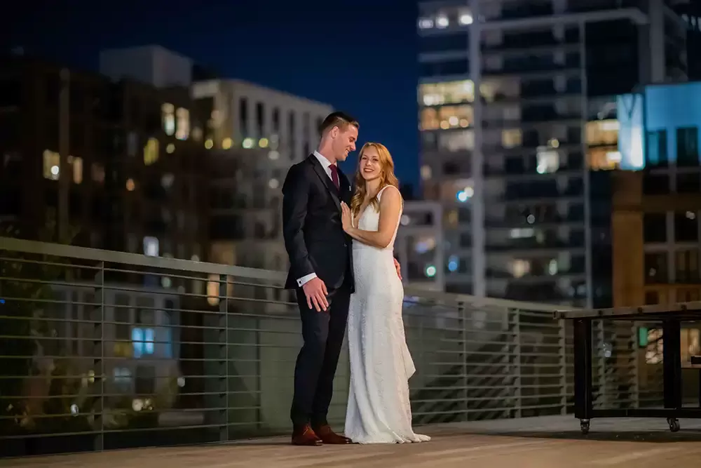 Portland Wedding Photographer Robert Knapp catches a couple during their wedding reception standing on the rooftop of the eco trust building. 