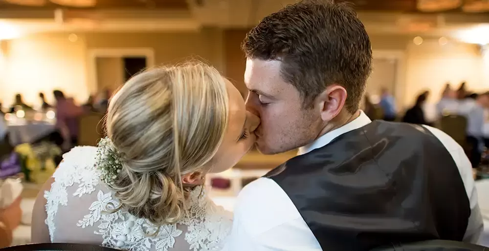 Alderbrook Resort Weddings
from ​Photographer Robert Knapp The bride and groom have a kiss the reception is out of focus in the background