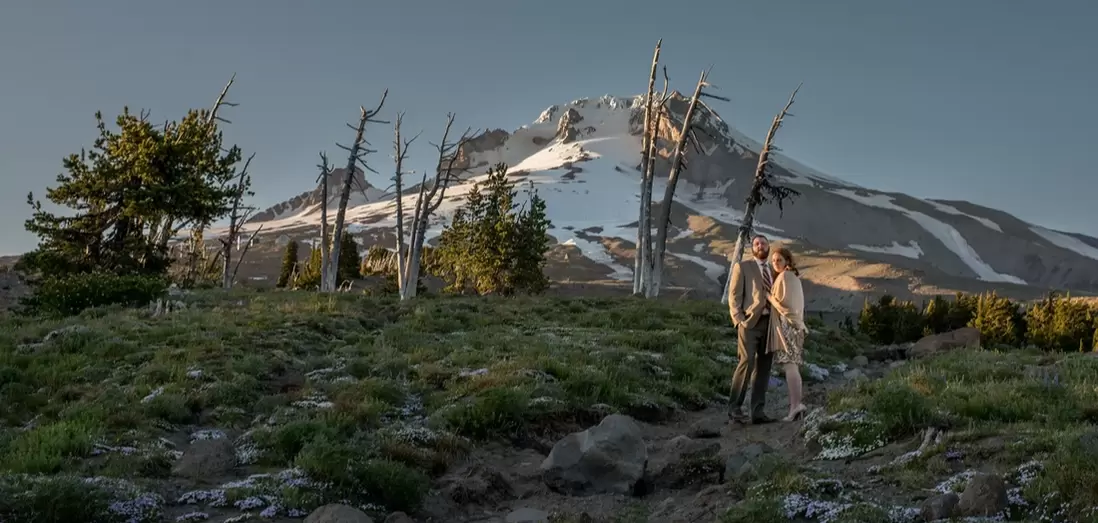 Wedding at Timberline Lodge ​from photographer Robert Knapp A bride and groom stand in front of Mount Hood at sunset as seen from a wedding at timberline lodge