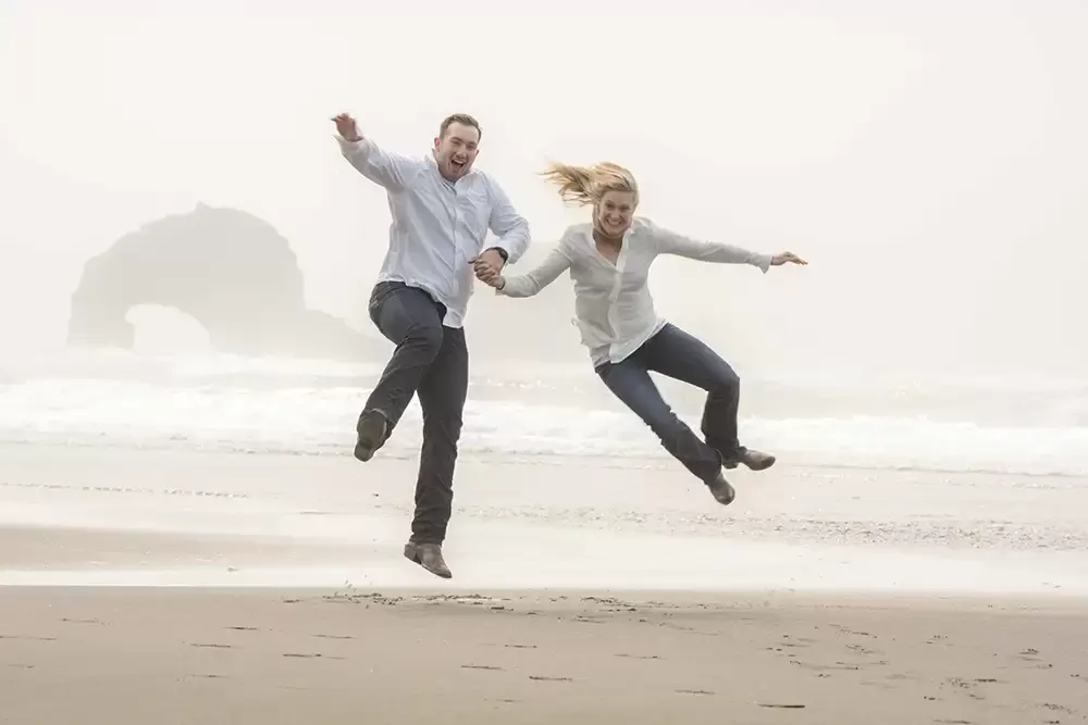 a couple kicks their heels on the Oregon Coast Engagement Photos 
With 
Modern Art Photograph